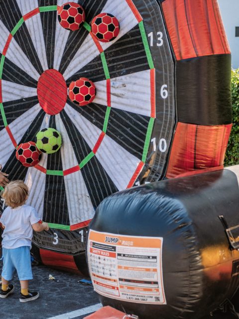 Giant inflatable dart board challenge at an outdoor event
